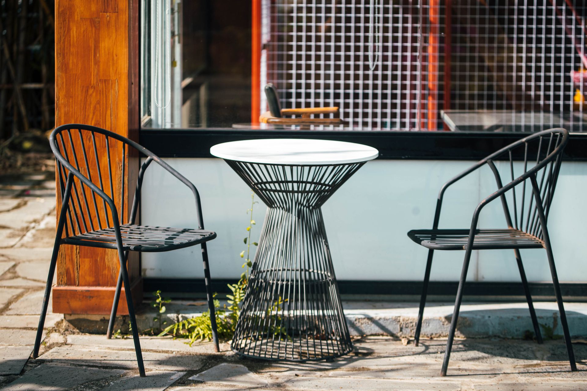 Bistro table and wire chairs outside a café