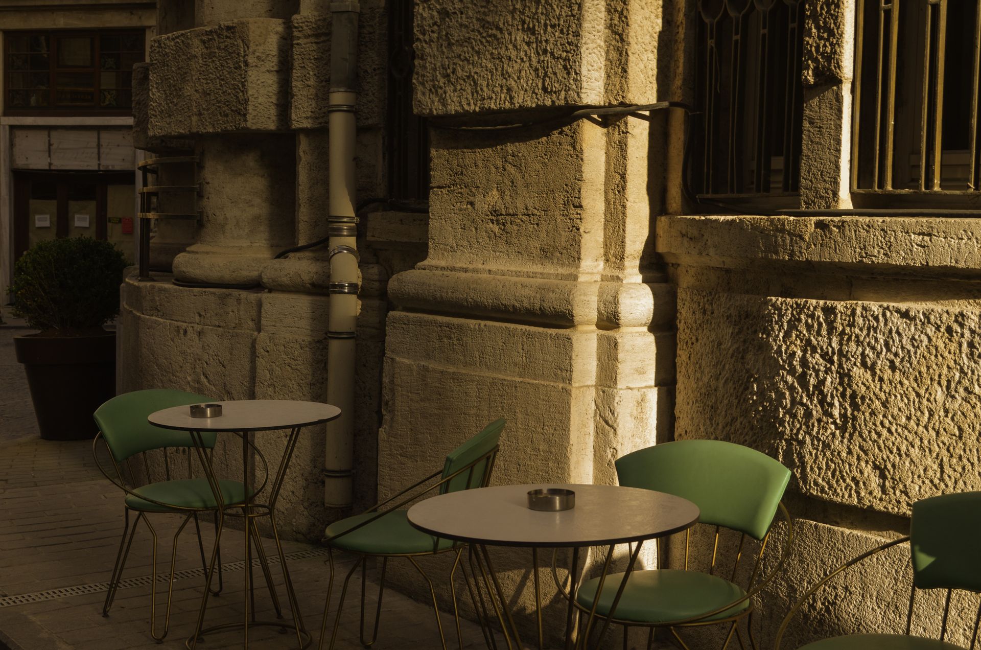 Outdoor café tables and chairs in golden light