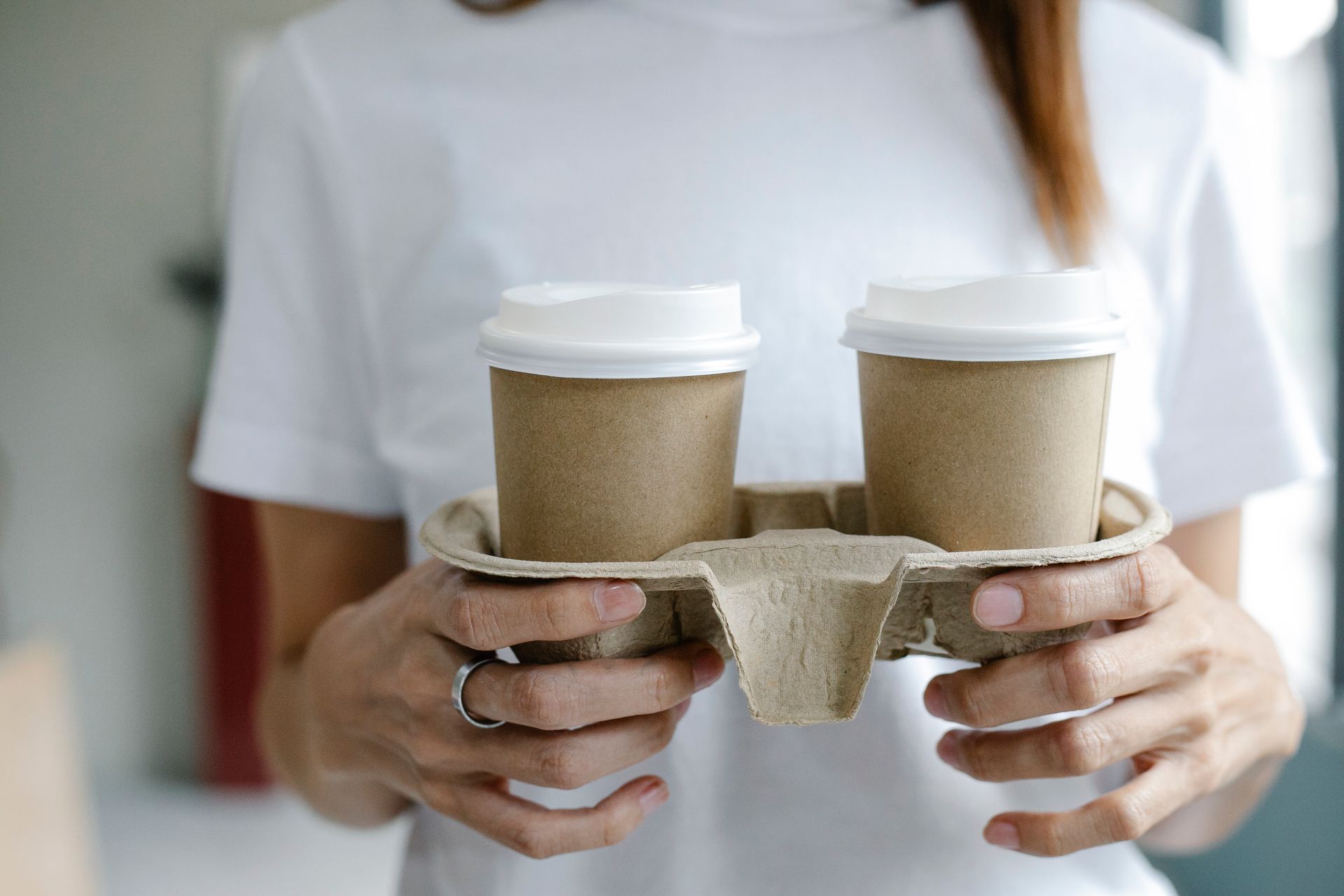 Two takeaway coffee cups in a carry tray